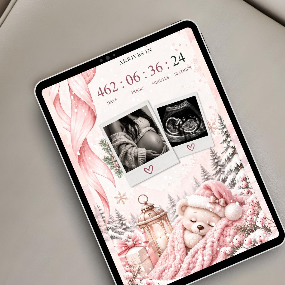 Christmas baby shower website displayed on a tablet with live countdown, ultrasound photos and cosy pink winter illustrations.