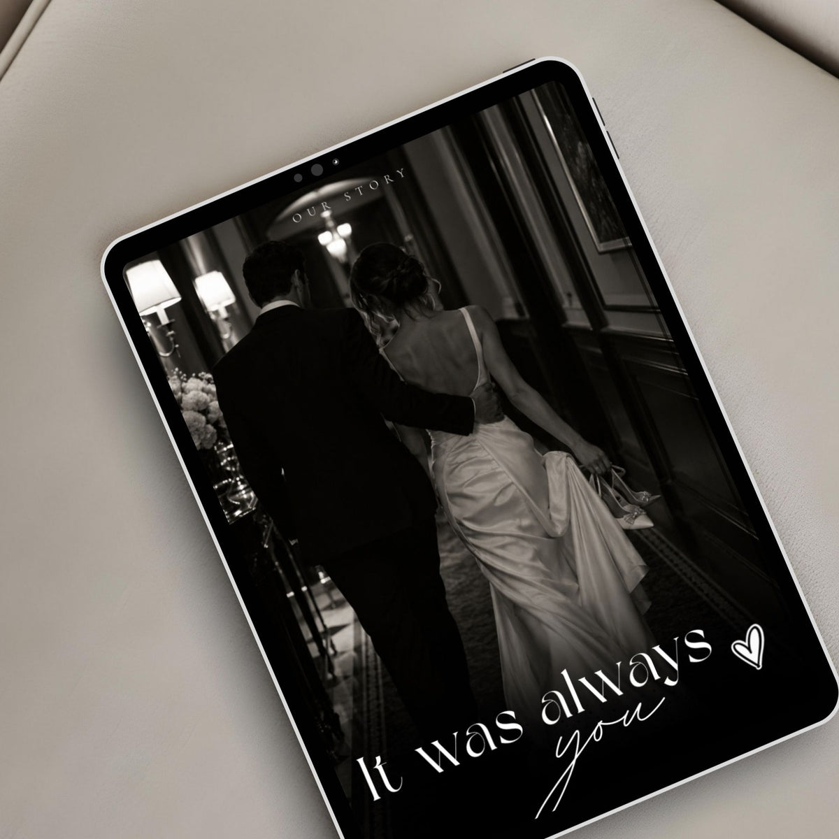 Elegant black-and-white wedding website displayed on a tablet featuring romantic couple photography and editorial wedding styling.