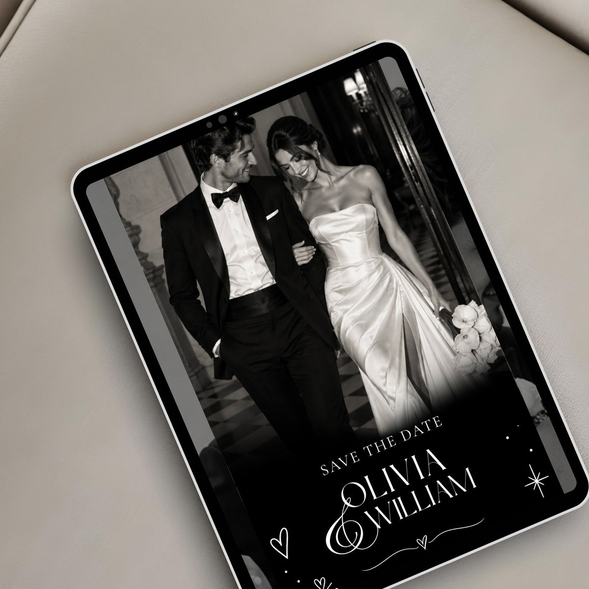 Editorial doodle save the date website displayed on a tablet, featuring elegant black and white couple photography and modern wedding typography.