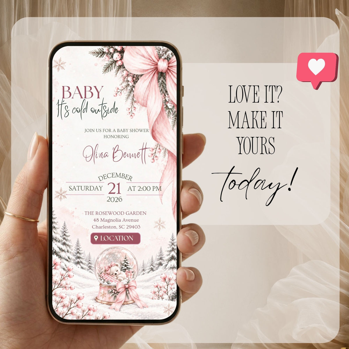 Pink Christmas baby shower invitation displayed on a phone with winter greenery, bows and editable event information.