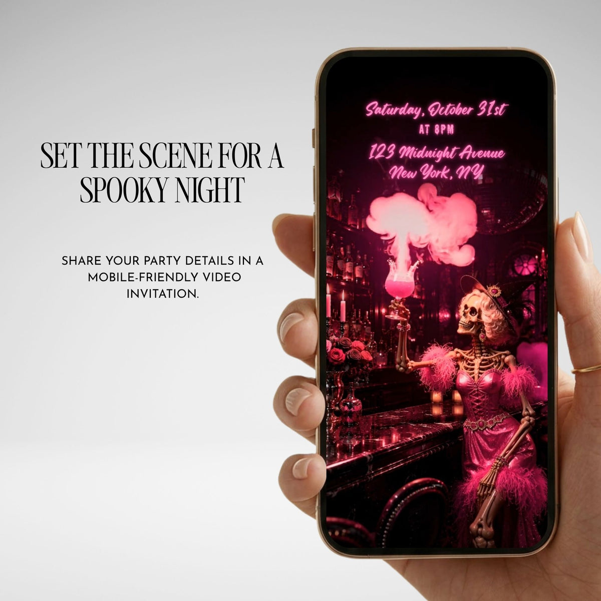 Pink Halloween party video invitation displayed on a phone with personalized event details and a dramatic spooky party aesthetic.